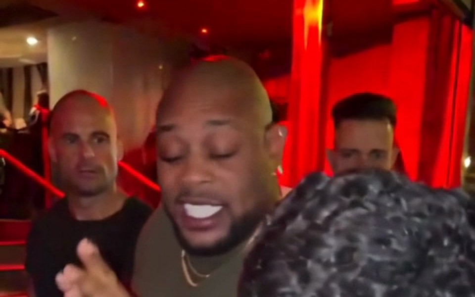 Bald man in an olive T-shirt in a freestyle video