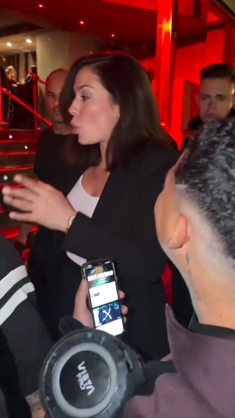 A woman with dark shoulder-length hair in a black blazer in the vertical night freestyle